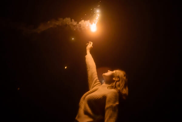 female holding fireworks