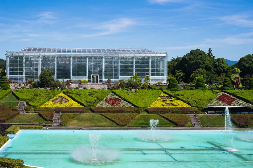 Greenhouse in front of a garden fountain
