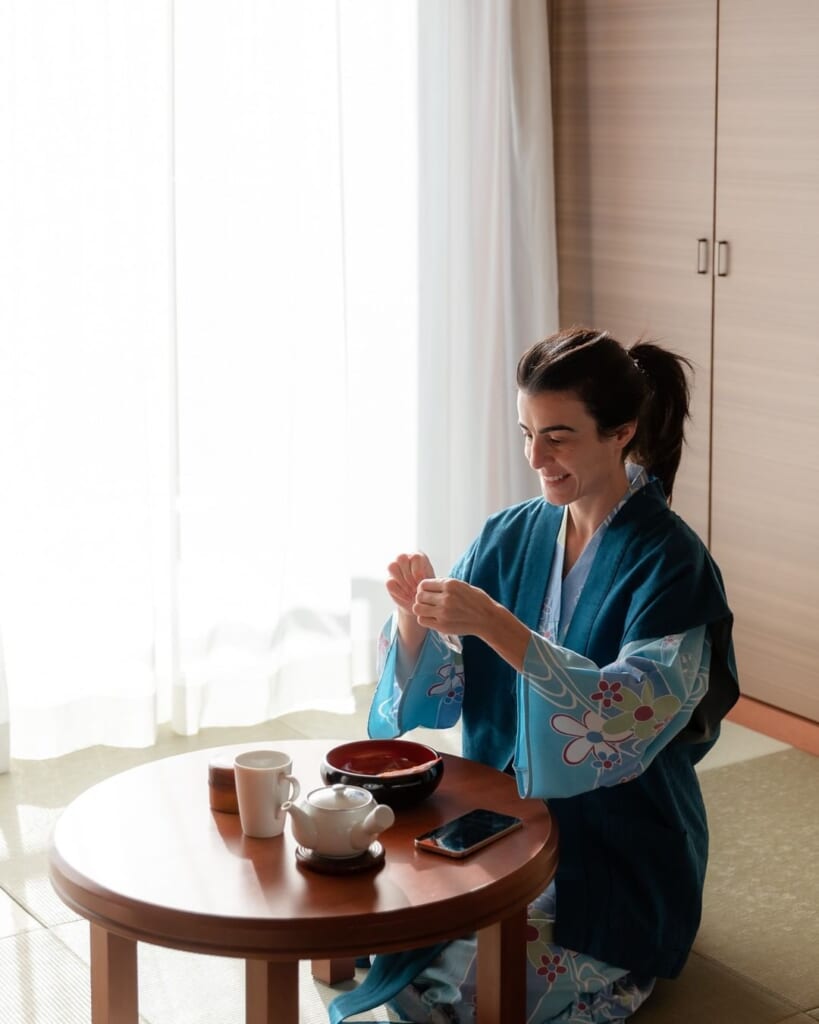 Woman having Japanese tea and sweets
