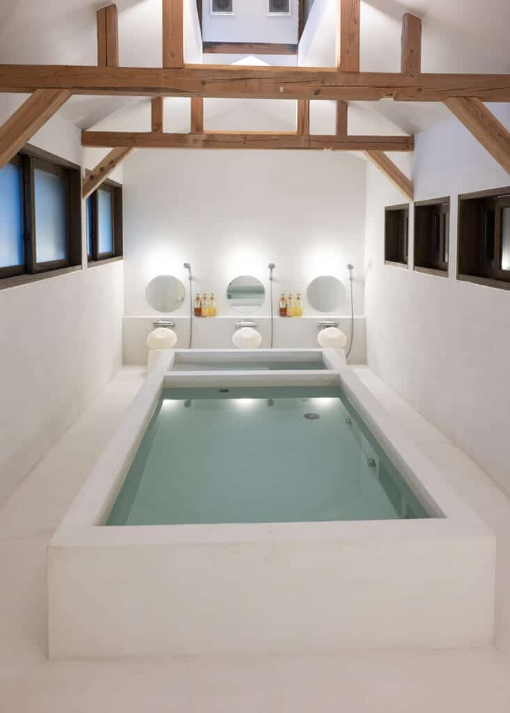 white walled luxury bathtub filled with water in japan