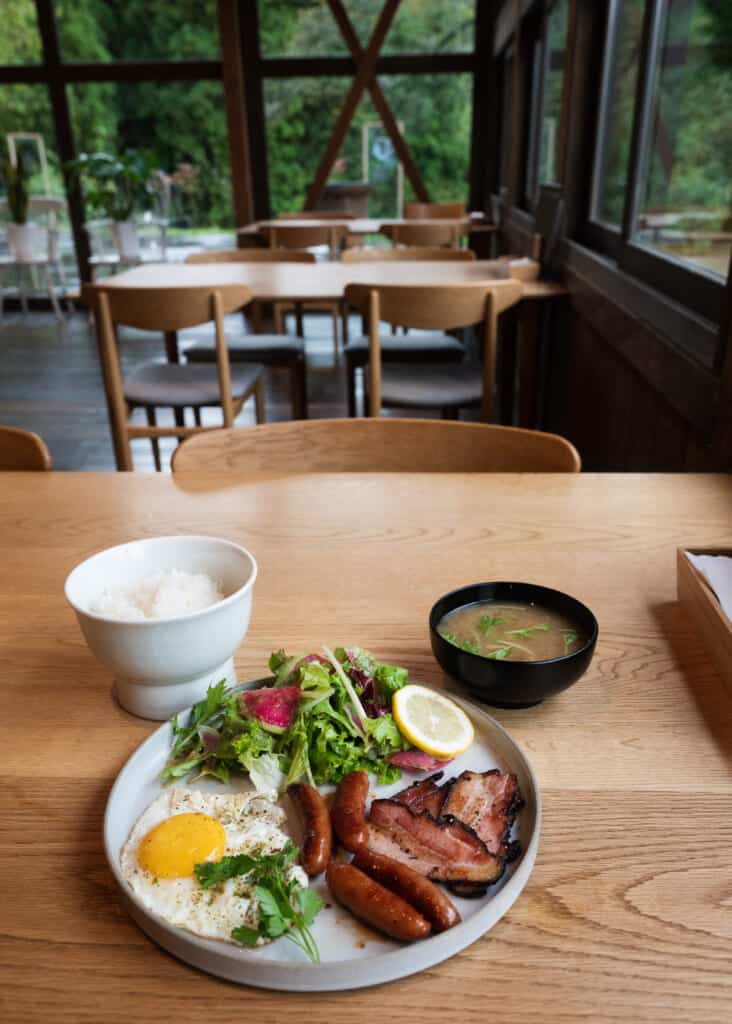breakfast of eggs, sausage and miso soup in a renovated Japanese accommodation