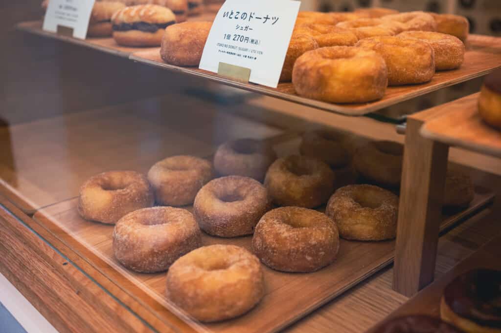 donuts behind a glass counter in japan