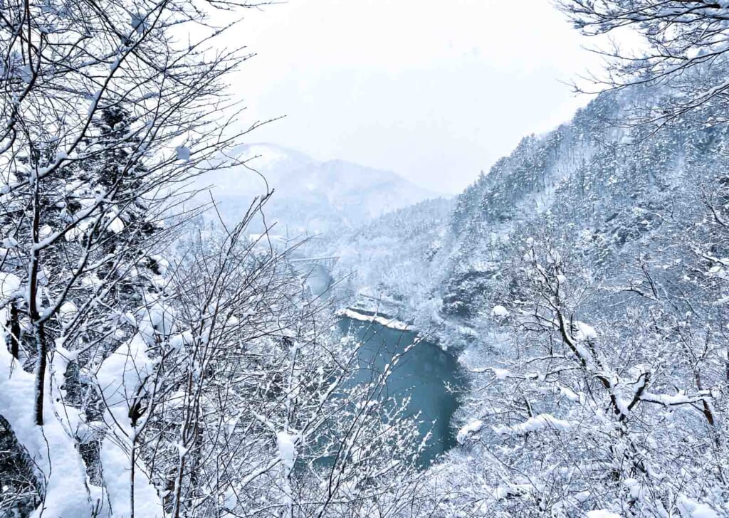 snowy mountain forest scene around Tadami River Bridge in Fukushima