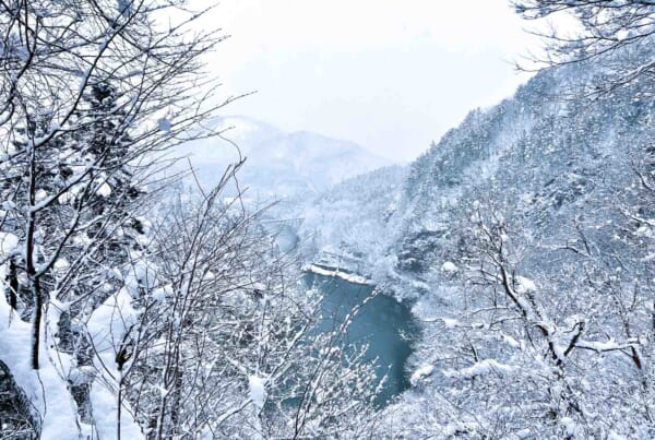 snowy mountains and blue valley with bridge in fukushima prefecture, japan
