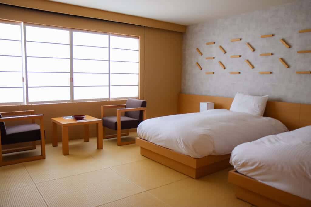 Japanese style onsen resort room with two beds and a tea table