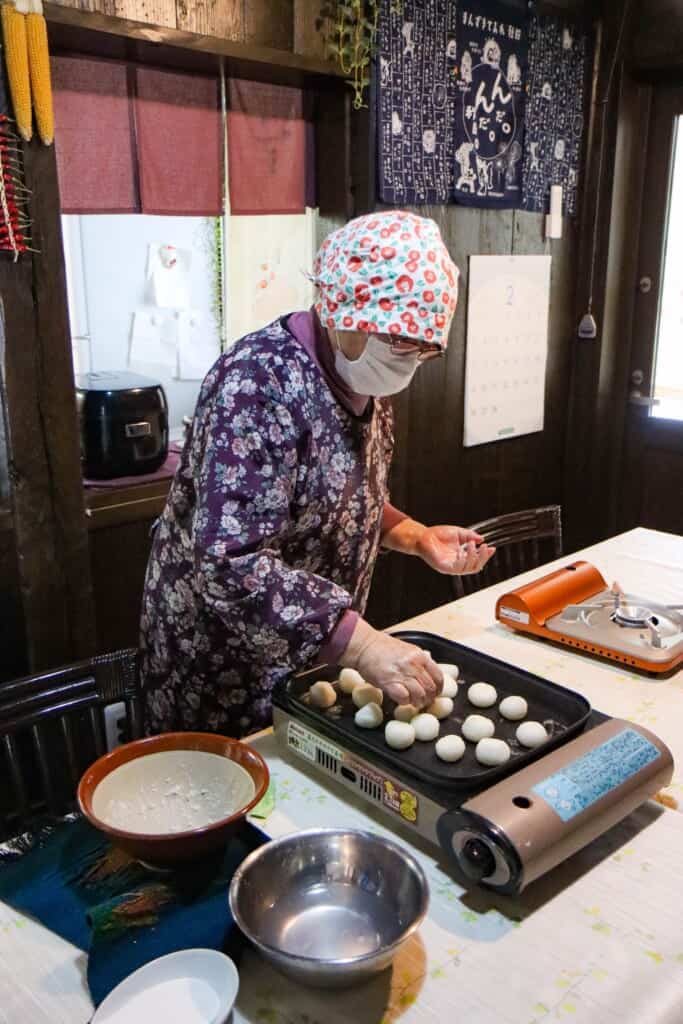 putting rice dumplings on the hot pan to fry in Semboku, Akita, Japan