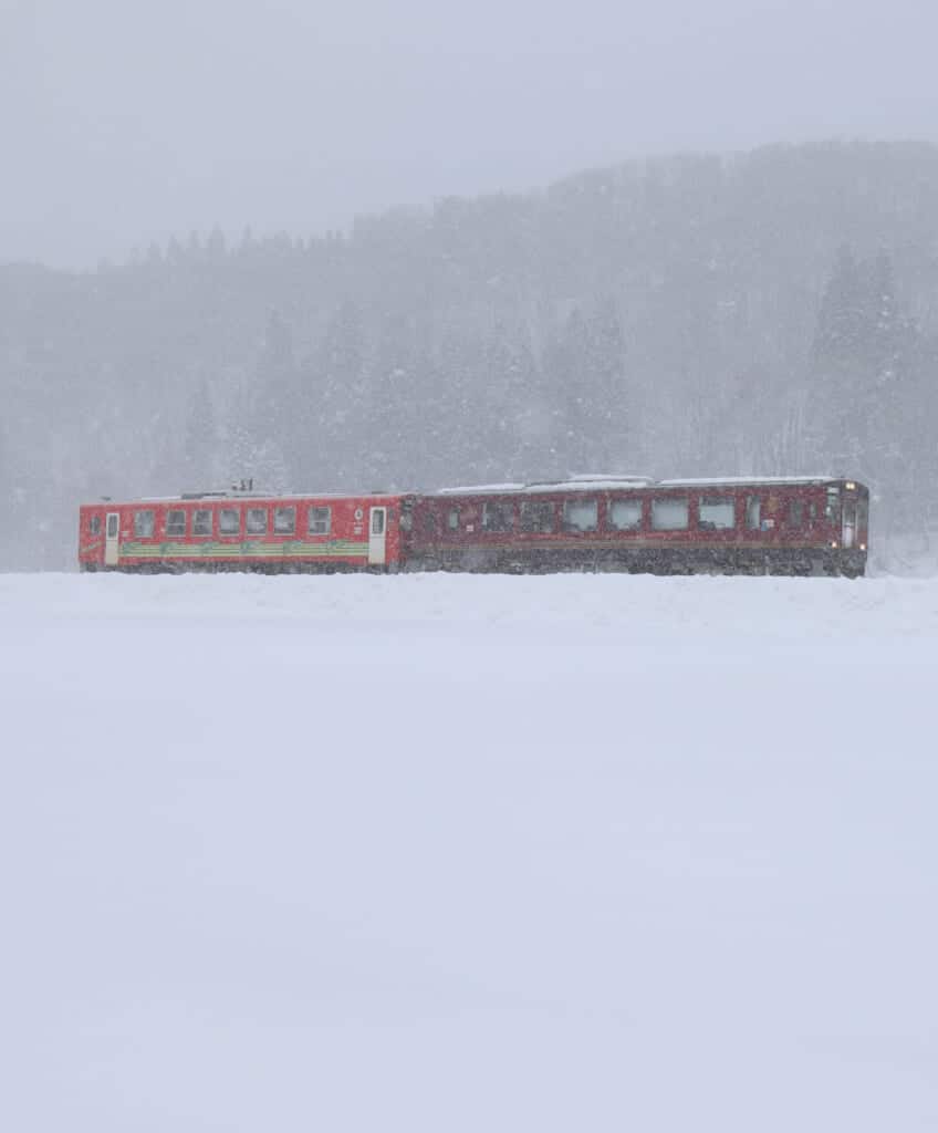 Red train in the snow from the Akita Nairiku Railway  in Semboku, Japan