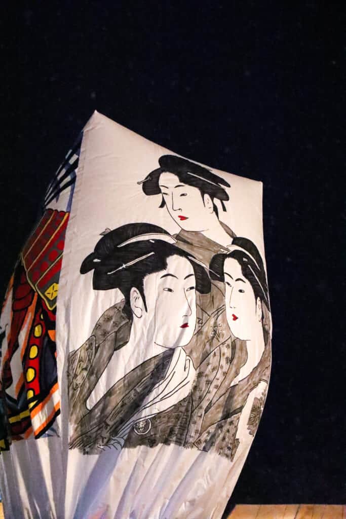 large paper balloon with a painting of geisha