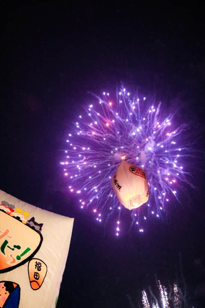 paper balloons in the sky with fireworks  in Semboku, Akita, Japan