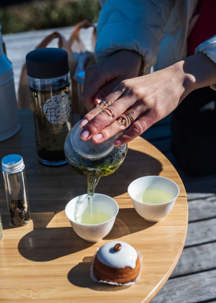 hand pouring green tea in japan