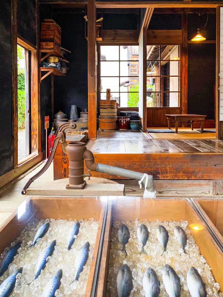 mock fishing booth and shop at open air fishing village museum in japan