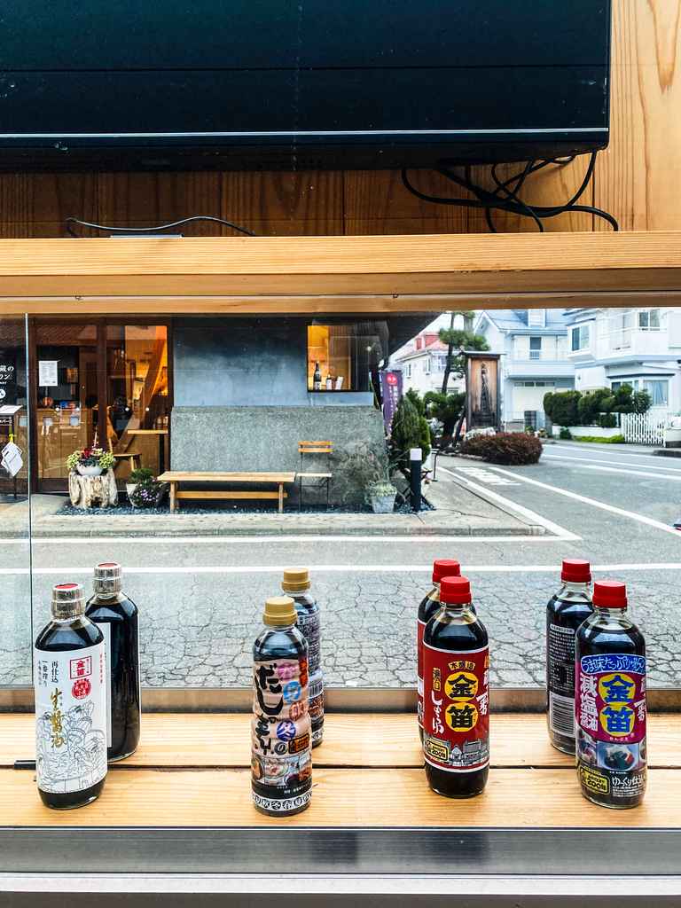 row of soy sauce bottles in window of Japanese shop in Japan