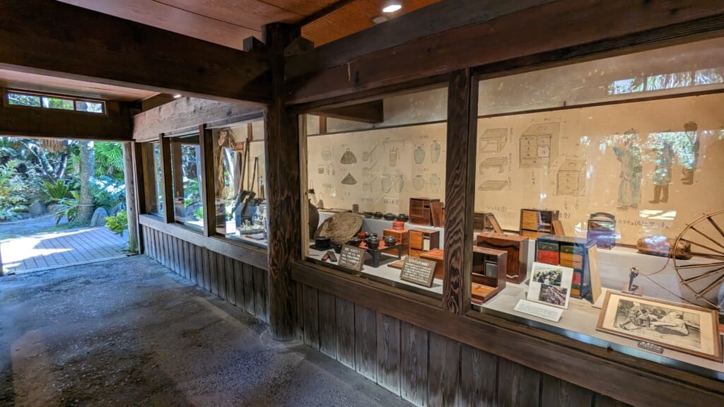 Exhibits showing tools and equipment for daily use and textile making at Amami no Sato 