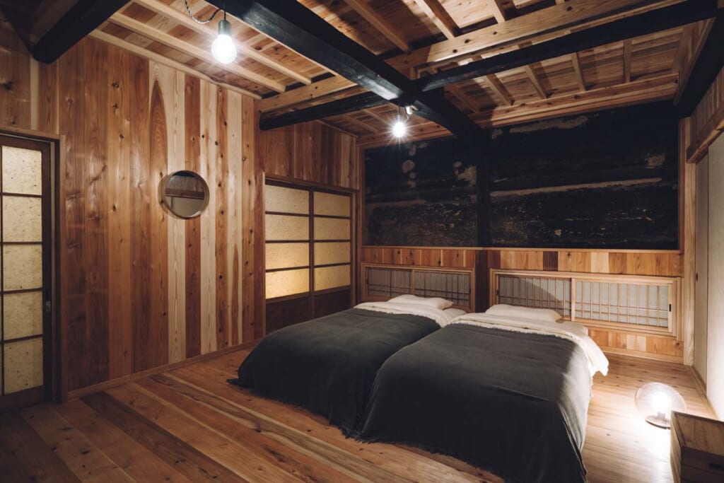 interior of traditional japanese house with two western style beds and dim lighting