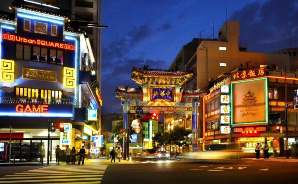 The brightly lit gates of Yokohama Chinatown at night.