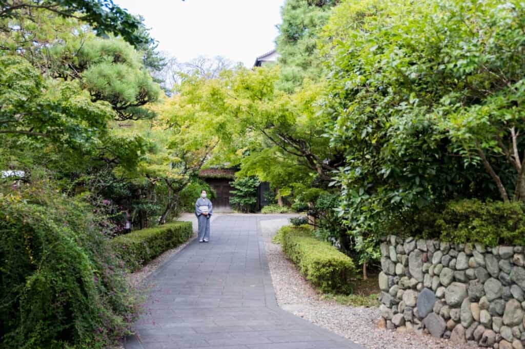 woman standing in japanese garden wearing a kimono