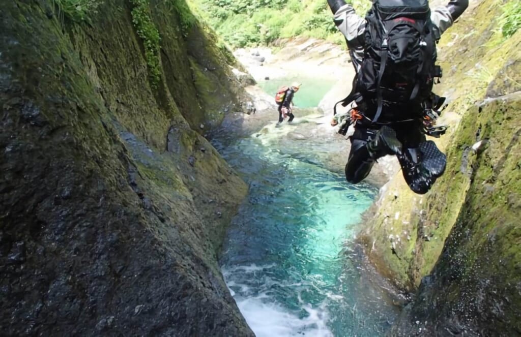 Canyoning at Kurobe River, two people doing extreme sports