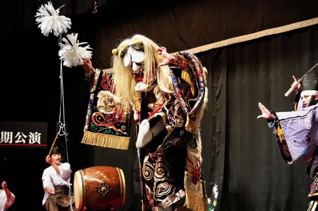 white-haired shogun character dances in kagura performance
