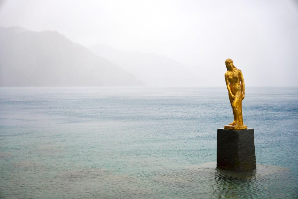 Tatsuko statue at Tazawa Lake on a misty day in Semboku, Akita
