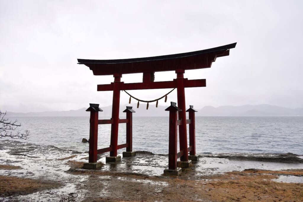 red torii on Tazawa Lake at Gozanoishi Shrine in Semboku, Akita