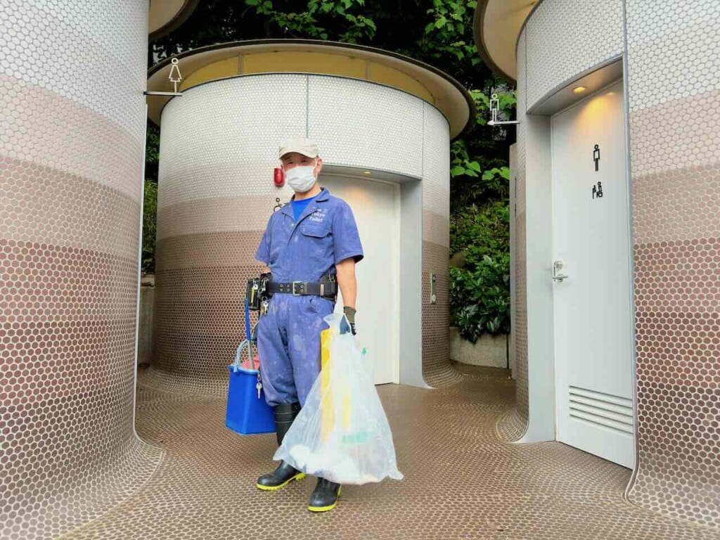 cleaner posing in front of Public Toilet in Yoyogi-Hachiman, Tokyo