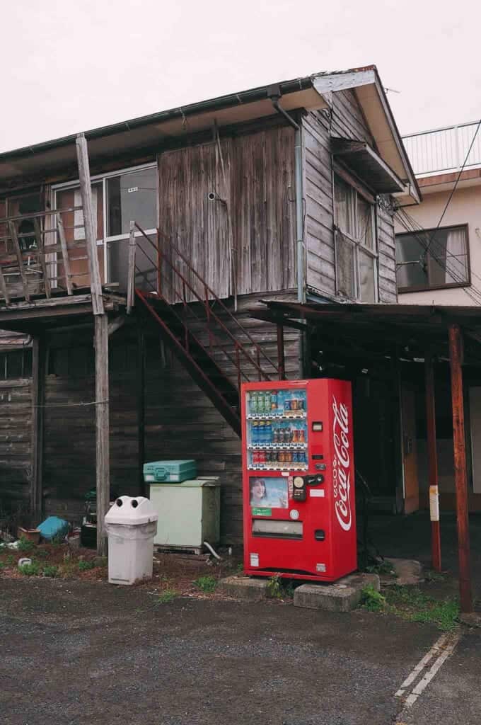 Vending machine next to a wooden house