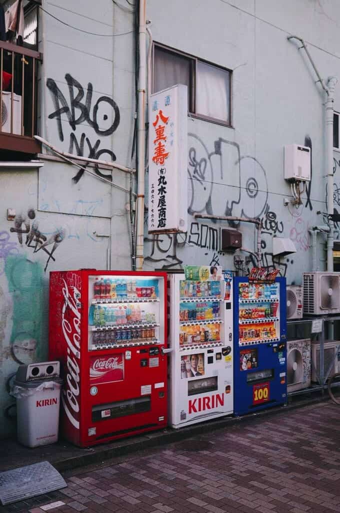 Vending machines with graffities on the wall