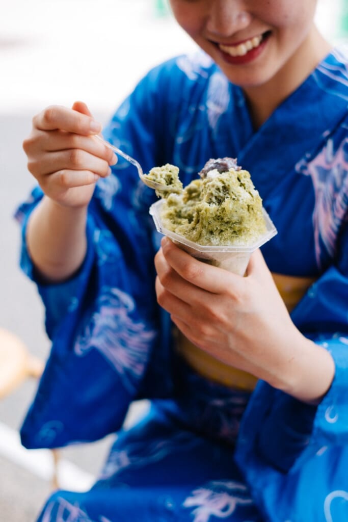 females dressed in a yukata and eating kakigori