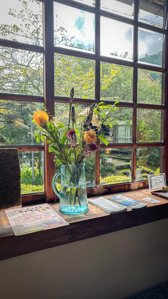 A flower bouquet in front of the windows