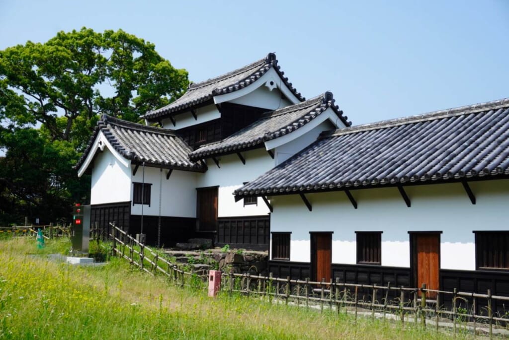 Black and white Fukuoka Castle Ruins turret against a blue sky