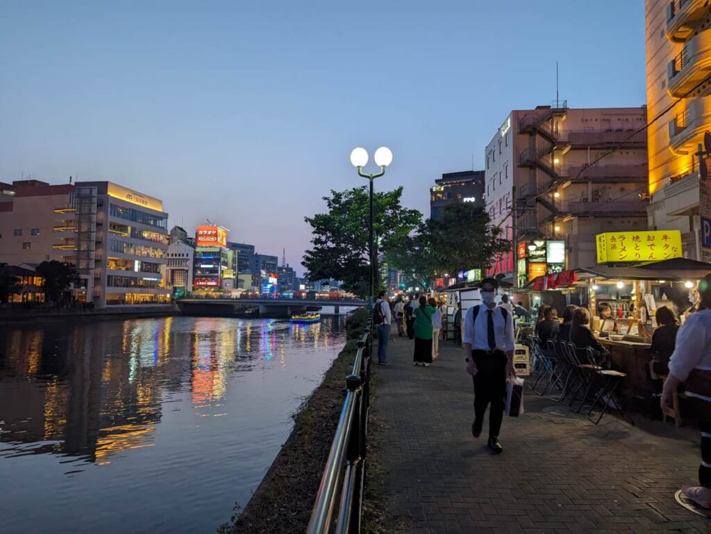 A river reflecting the Fukuoka cityscape.