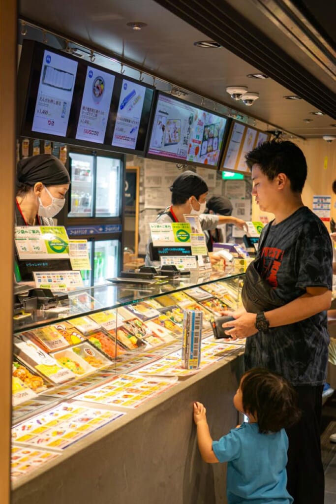 A man and a child buying train bentos in Tokyo Station