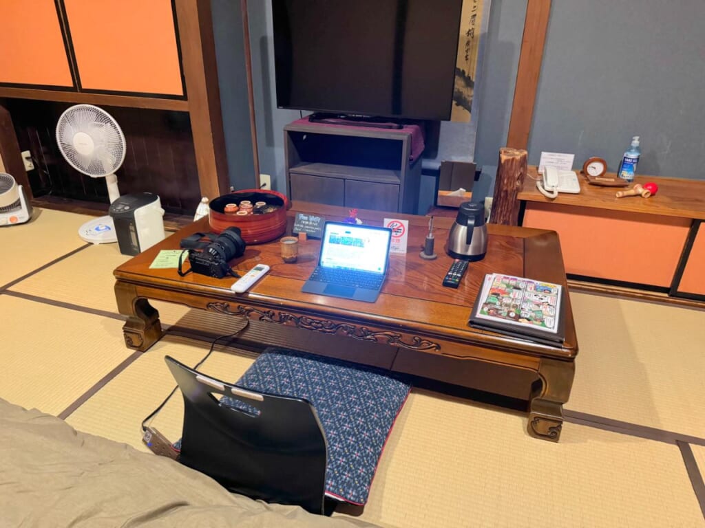 A small laptop on a table in a traditional Japanese tatami room