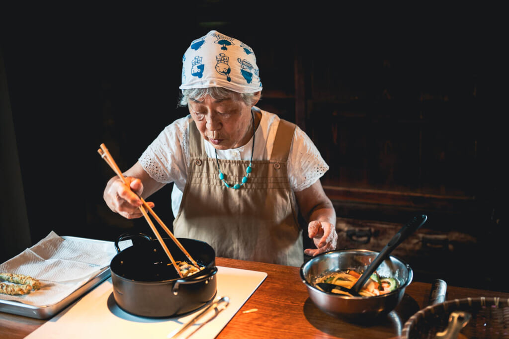 woman cooks local food on ojika island