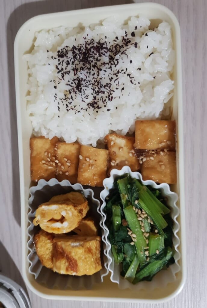 Japanese bento with tofu, tamagoyaki and komatsuna