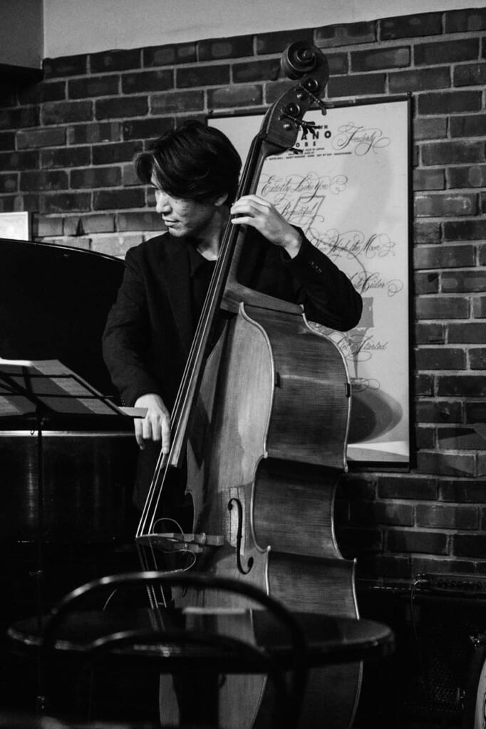 Male bassist performs at Sone jazz bar in Kobe Japan