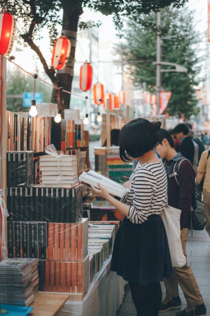 Femaale reading in a used secondhand book in Tokyo