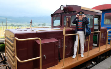 Je pose devant la locomotive du train torokko, coiffée de la casquette du conducteur de train
