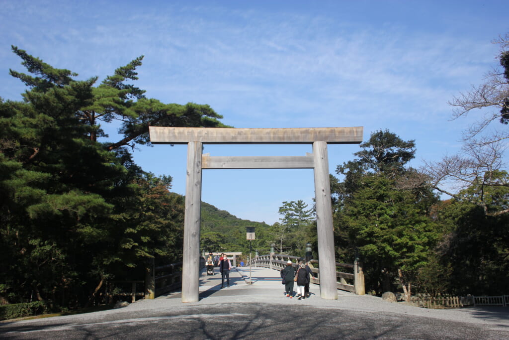 A wooden shrine gate leads to a bridge