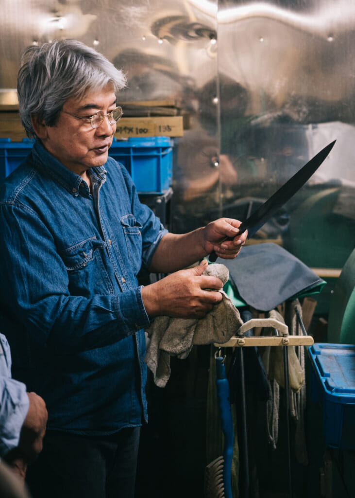 Un maître forgeron travaillant la lame d'un couteau japonais