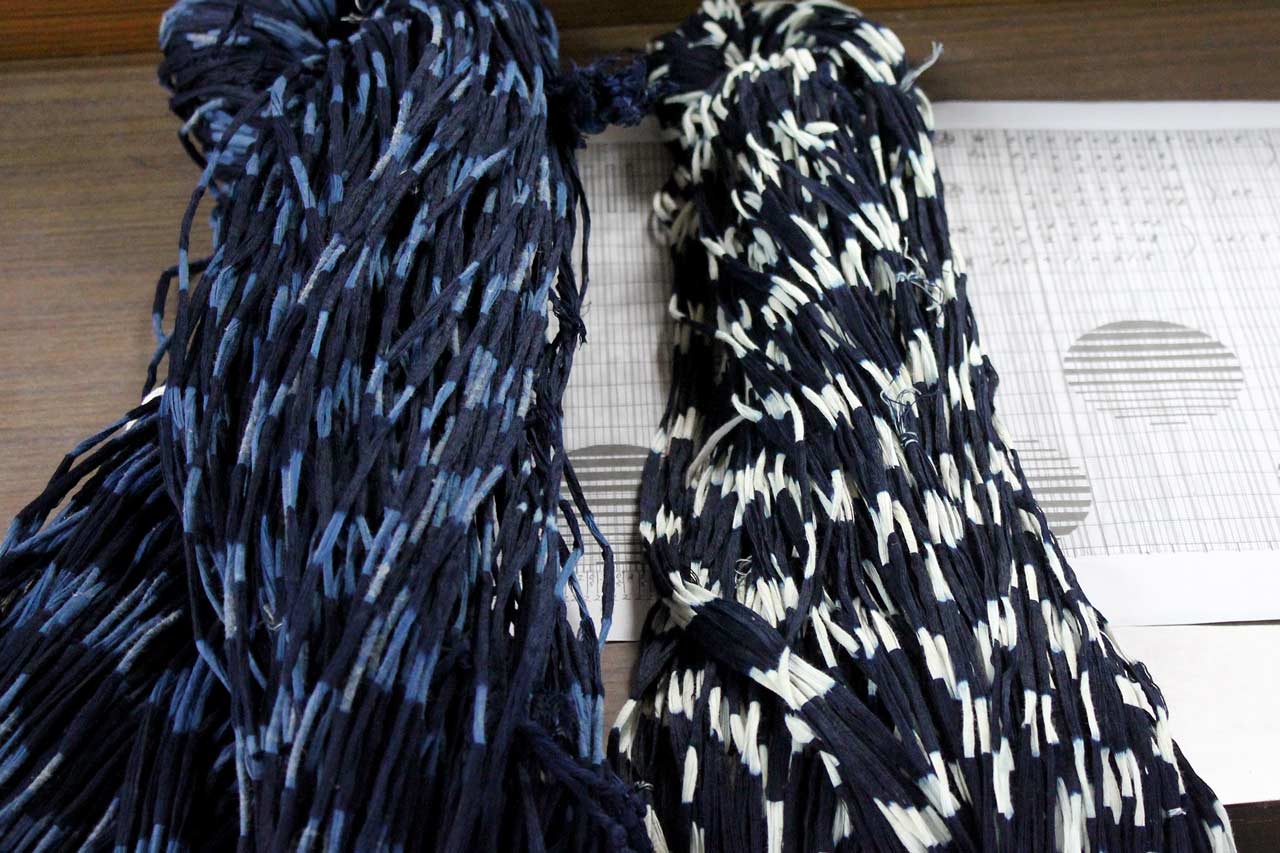 Deux échevettes de Kurume kasuri après teinture: l'une est bleue et blanche, l'autre présente un dégradé de bleus.