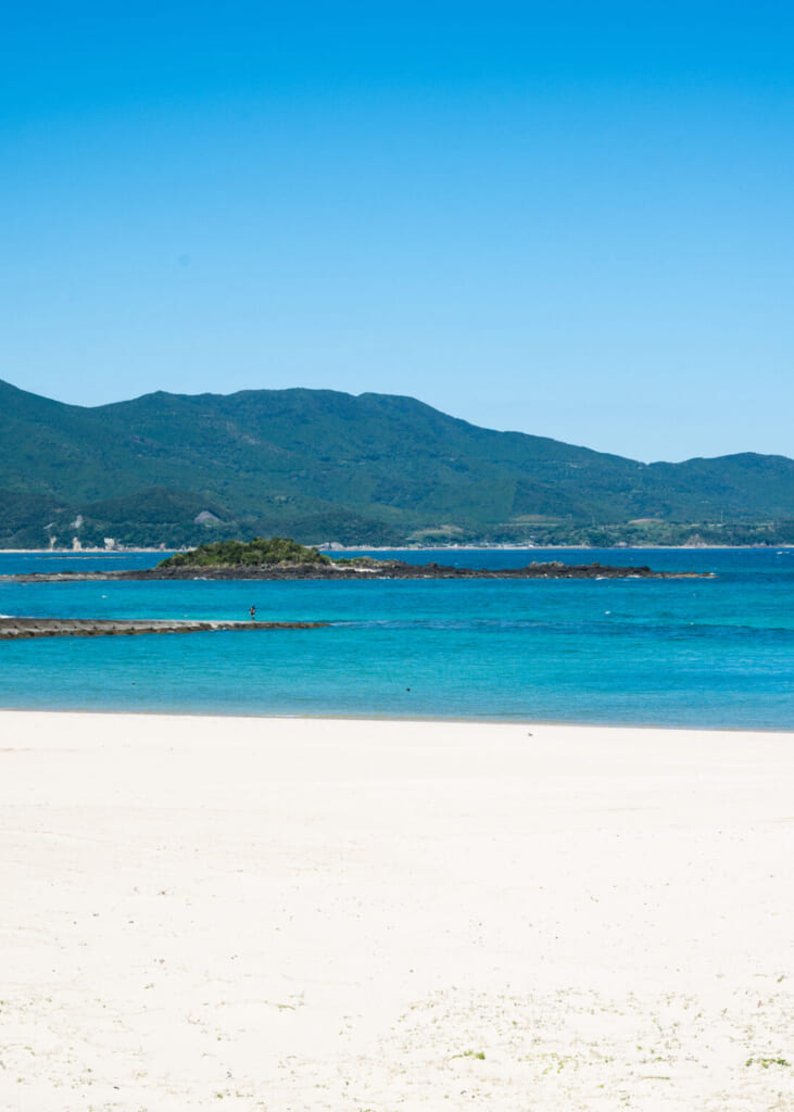 plage au sable blanc devant la baie turquoise au large de l'île de Fukue