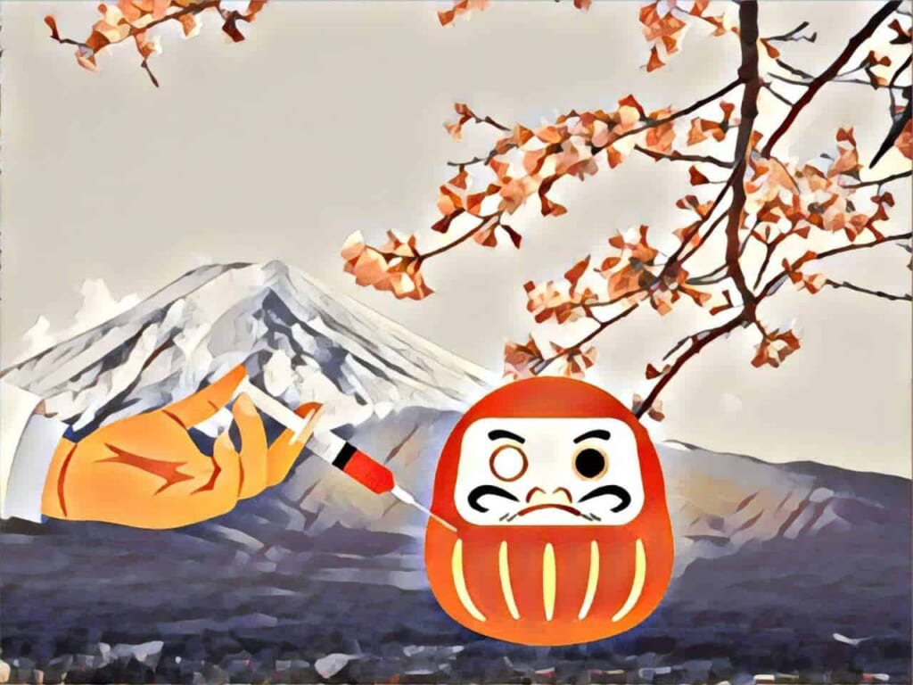 una mano fa un'iniezione a un daruma con il Monte Fuji sullo sfondo